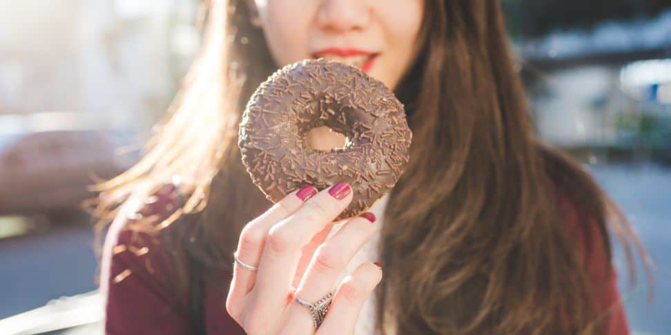 woman holding a doughnut